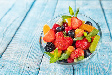 Fresh fruit salad served on wooden table