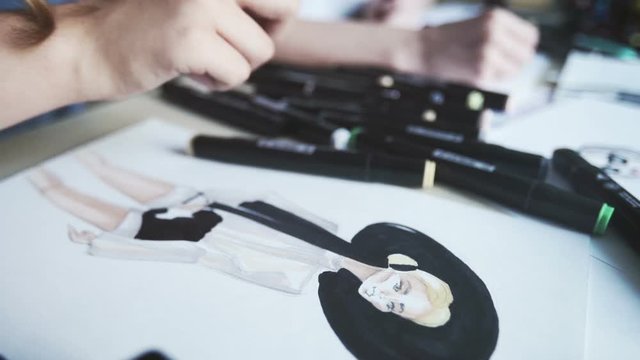 Fashion designer drawing and paint. Female fashion designer drawing sketches for clothes. Close-up