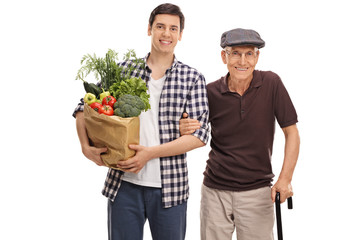 Man holding groceries with his grandpa