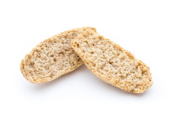 Dry flat bread crisps with herbs on a white background.