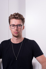 smart young professional with serious look into camera