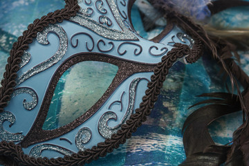 Naklejka premium Blue and black female carnival mask on the blue background