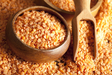 Red lentils, wooden scoop and bowl