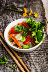 Bowl of Thai soup with fresh ingredients