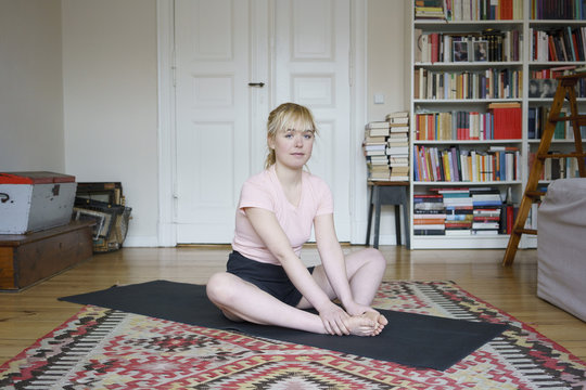 Portrait of young woman doing yoga at home