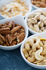 Variety of nuts in small bowls