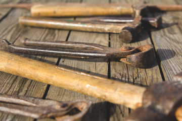 Rusty set of hand tools on a wooden background. Vintage photo
