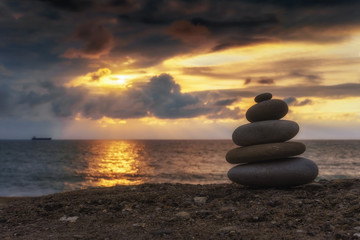 stack of zen stones at sunset