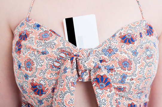 Closeup of woman chest holding credit card at the bra