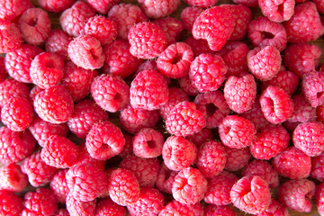 Ripe sweet juicy raspberries on wooden table. Close up, top view