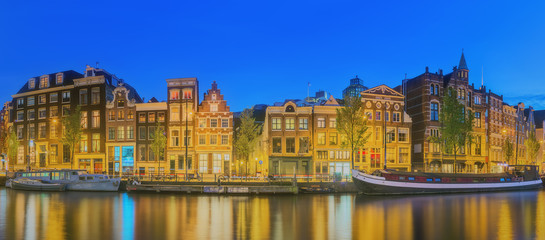 Fototapeta na wymiar Amstel river, canals and night view of beautiful Amsterdam city. Netherlands