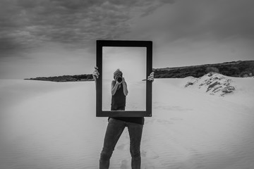 Photographer in the mirror,woman photographer in the mirror taking self portrait,one other girl holding the mirror,black and white abstract concept