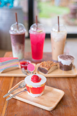 Delicious cheesecake with strawberries on wooden table