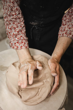 Potter master mashing the clay