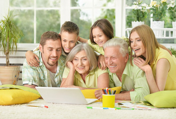 family at home with laptop
