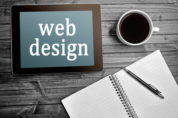 The words Web design on tablet