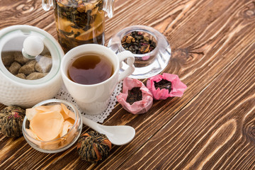 Tea cups with teapot on old wooden table