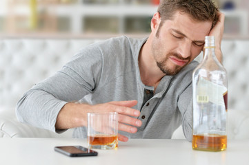 man with whiskey in glass