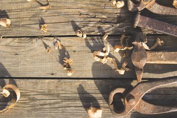 Rusty set of hand tools on a wooden background. Vintage photo