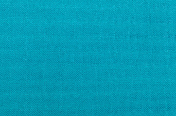 Light blue background from a textile material. Fabric with natural texture. Backdrop.