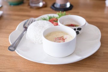 boiled rice with steamed eggs  on wood table
