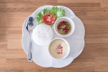 boiled rice with steamed eggs  on wood table
