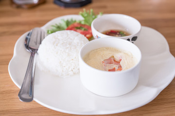 boiled rice with steamed eggs  on wood table