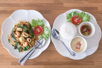 boiled rice with steamed eggs  and spicy spaghetti seafood on wo