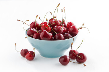 bowl of fresh cherries on a white background