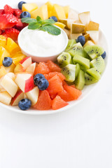 fresh ingredients for fruit salad and natural yoghurt on plate
