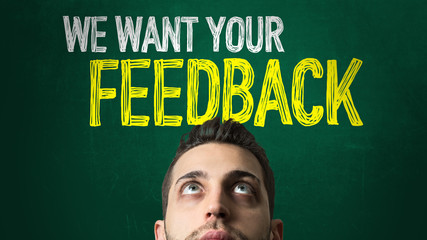 Guy Looking Ahead in a Chalkboard with the text: We Want Your Feedback