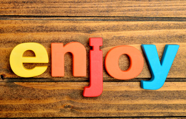 The word Enjoy on table