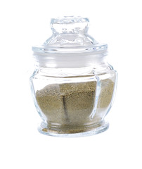 Dried Moringa powder in glass on white background
