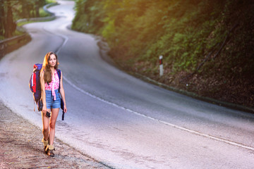 Backpacker Girl Walking by the Forrest road