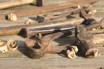 Rusty set of hand tools on a wooden background. Vintage photo