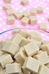 Brown sugar cubes in porcelain bowl