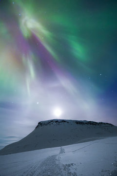 Aurora borealis over mountain, Finland