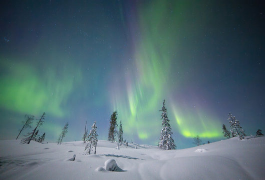 Aurora borealis over snowscape, Finland