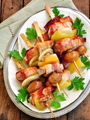 Pork wrapped in bacon on skewers grilled with onions, mushrooms and peppers.