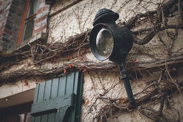 Fototapeta na wymiar Old wall lantern in a rustic style
