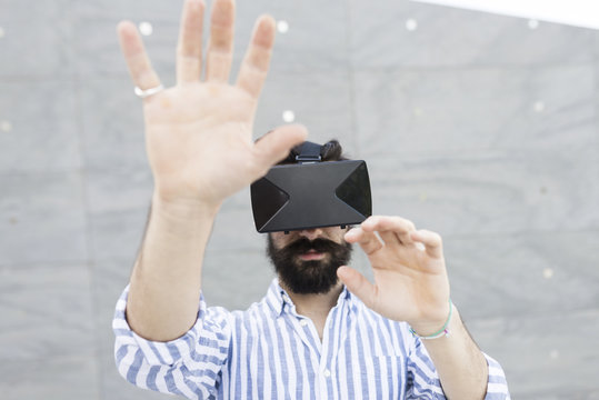 Man playing with Virtual Reality Glasses