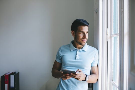 Young businessman in office using digital tablet