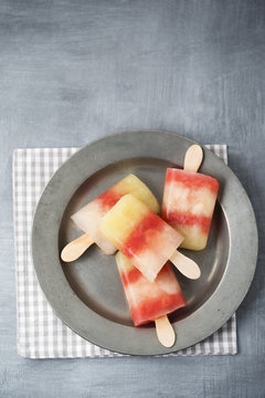 Plate of different homemade melon ice lollies