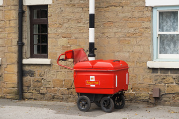 KIRKBY-IN-ASHFIELD, ENGLAND - JUNE 27: A Royal Mail high capacity trolley chained to a post. In Kirkby In Ashfield, Nottinghamshire, England. On 27th June 2016.