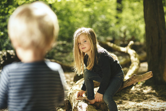 Brother and sister playing in forest