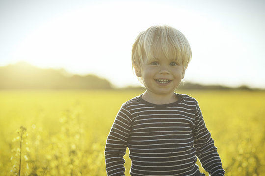 Portrait of smiling boy in canola field