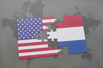puzzle with the national flag of united states of america and netherlands on a world map background