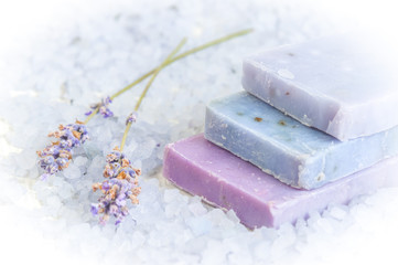 Natural soap, lavender, salt on a wooden board, hygiene items for bath and spa.