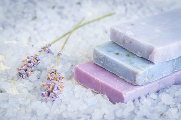Natural soap, lavender, salt on a wooden board, hygiene items for bath and spa.