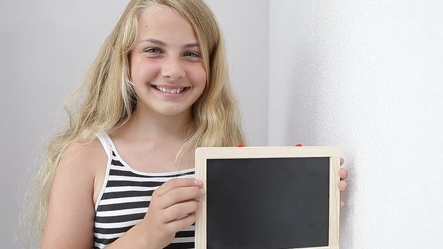youth girl holding a empty chalkboard